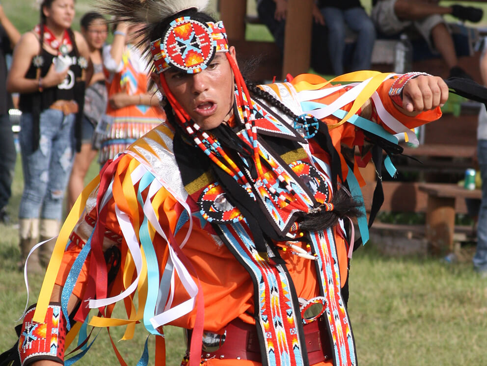 Man dancing in traditional Native American clothing